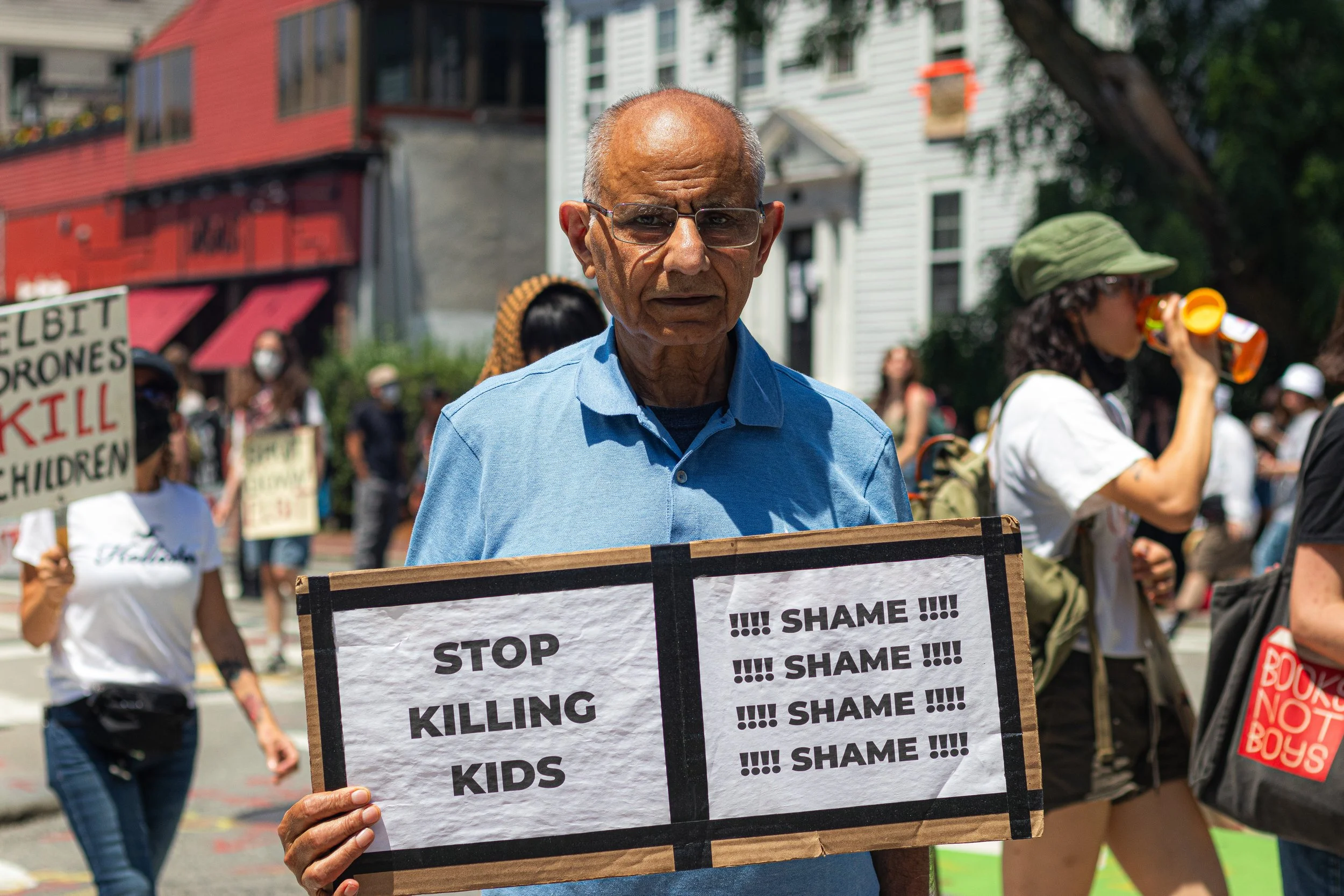 A man protests outside the Democracy Center in Cambridge on July 3.