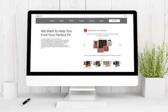 Computer monitor on white desk displaying a website about finding perfect fit for home decor, with fabric swatches and color options, next to a small plant and a mug.