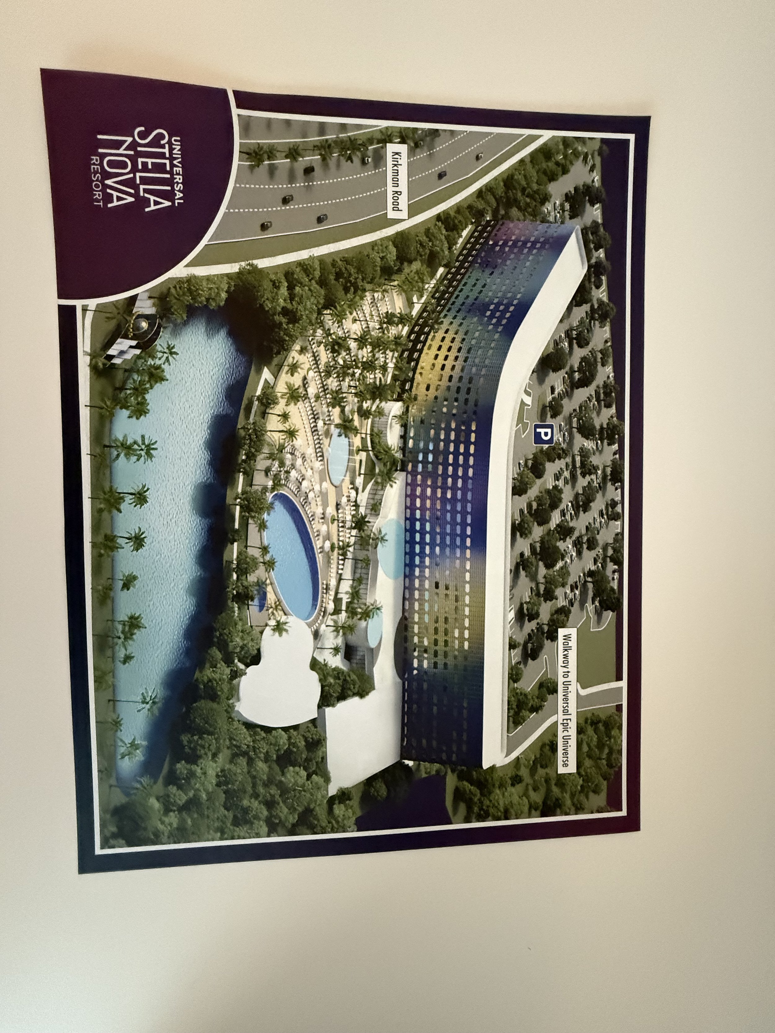 Aerial view rendering of Universal's Ohana/Resort hotel with pools, water features, trees, parking lot, and walkways.