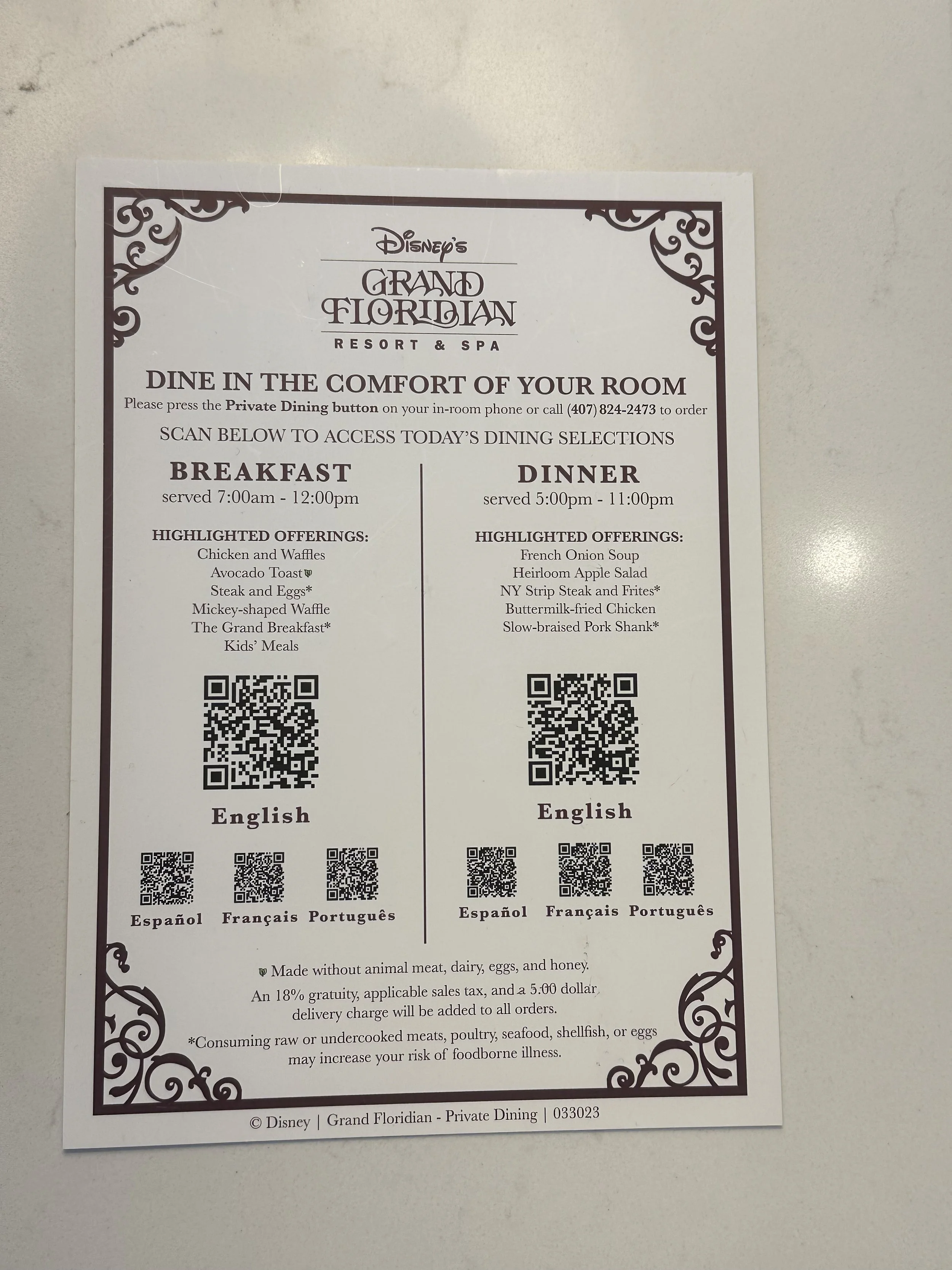 Dining menu for Disney's Grand Floridian Resort & Spa, featuring breakfast served 7am-12pm and dinner served 5pm-11pm, with QR codes for accessing menu options in multiple languages, and highlights including chicken and waffles, avocado toast, steak 
