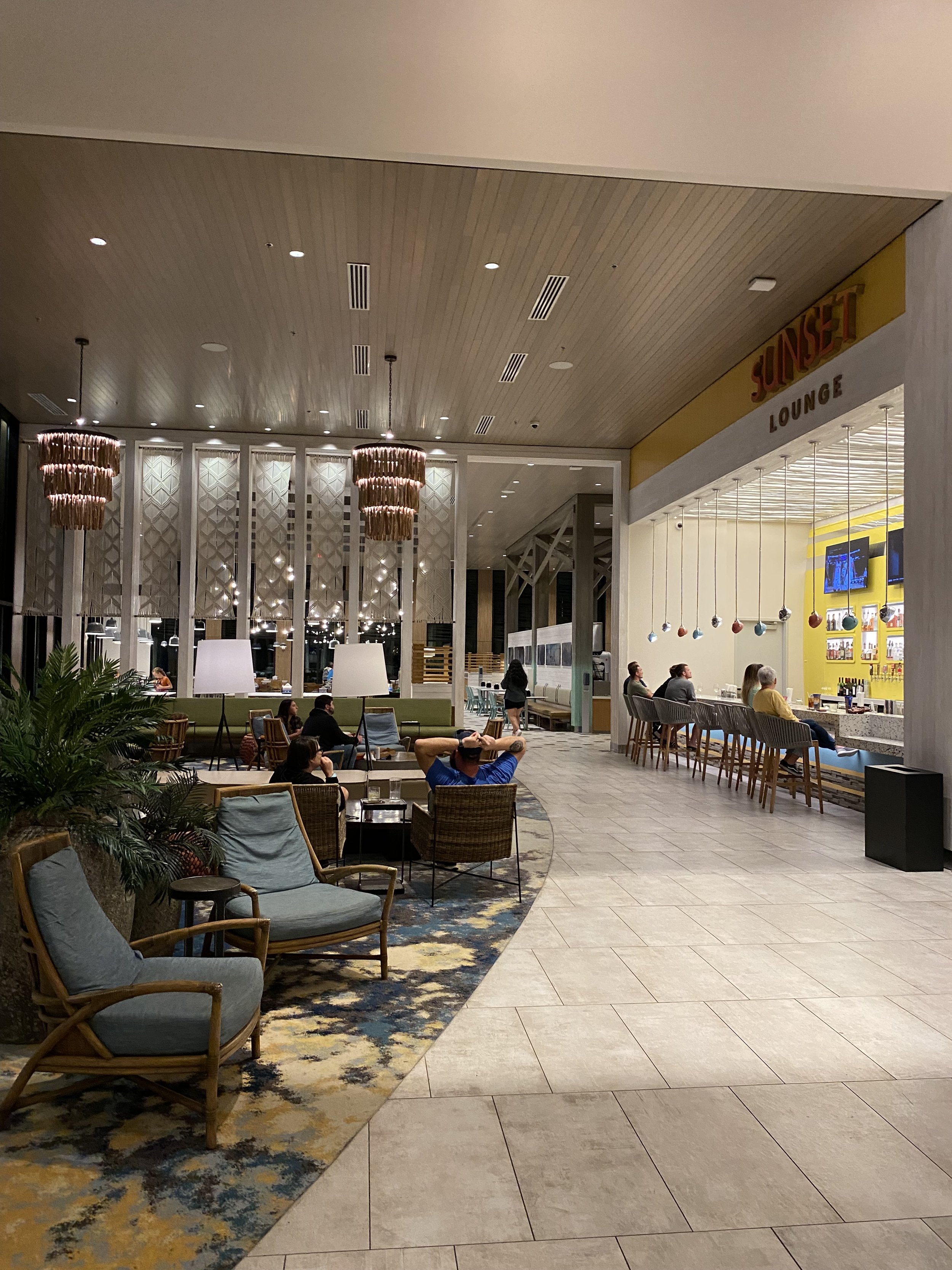 Indoor lounge area at Sunset Lounge with seating, bar, and decorative lighting.