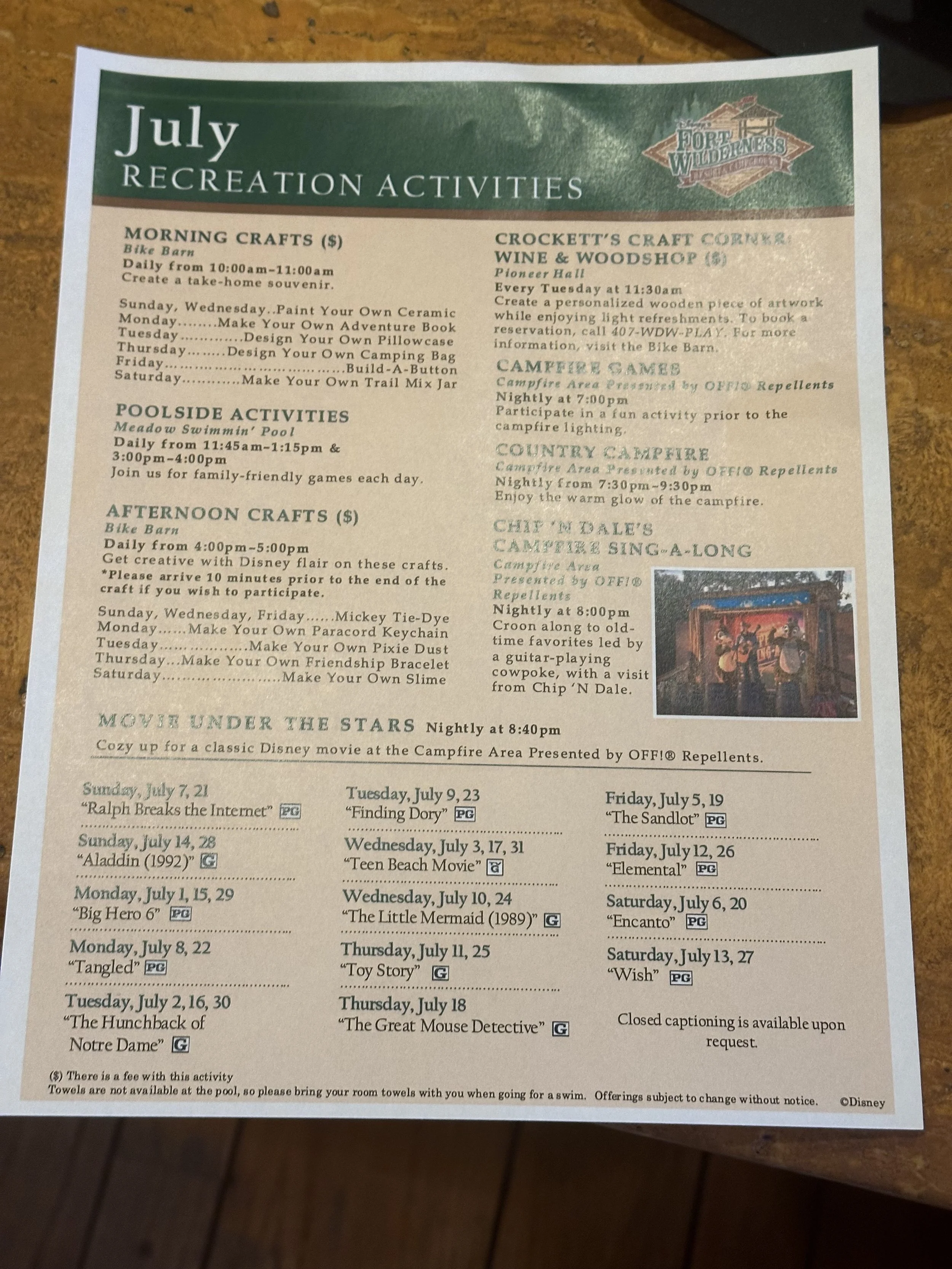 July recreation activities schedule at Fort Wilderness. Includes morning crafts, poolside activities, afternoon crafts, campfire games, and a movie under the stars with dates and times listed for specific events and movies.