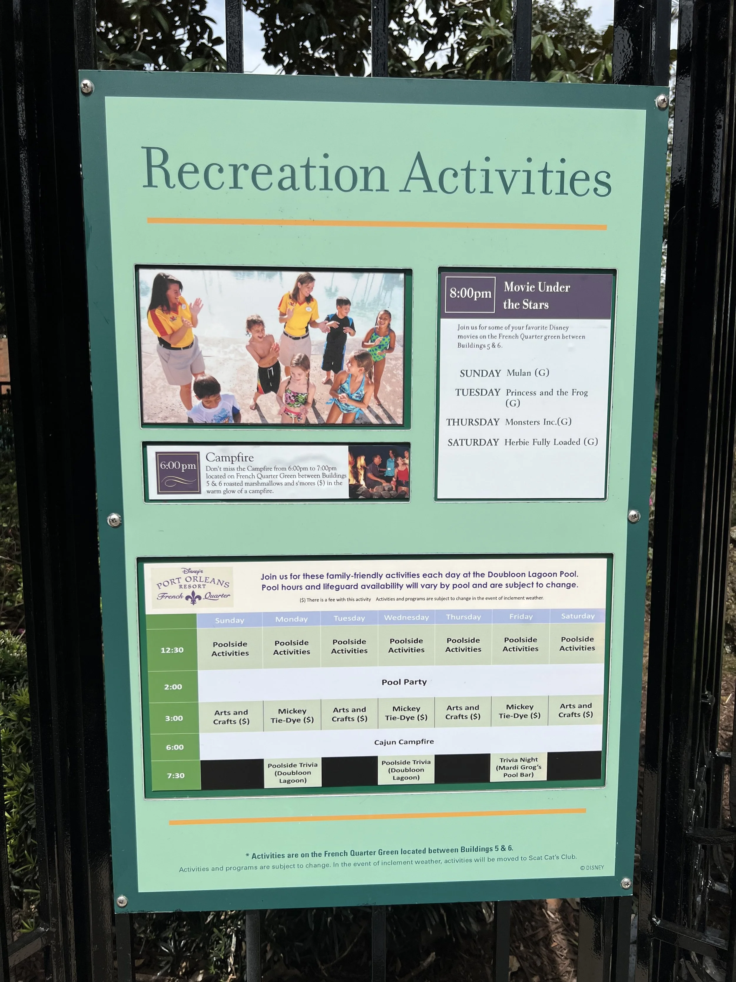 Status board at Disney Port Orleans French Quarter Resort listing recreation activities, including movie under the stars, campfire, poolside activities, pool party, and trivia night, with schedules and descriptions.