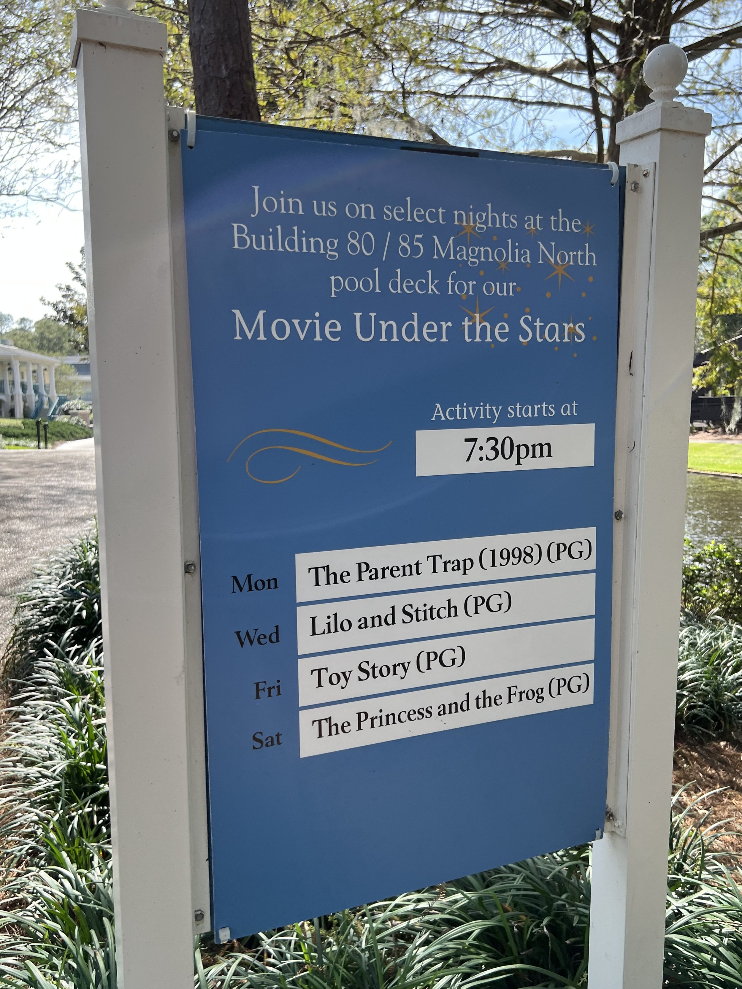 Schedule sign for outdoor movie nights at Magnolia North pool deck, starting at 7:30 pm with movies on Monday, Wednesday, Friday, and Saturday.