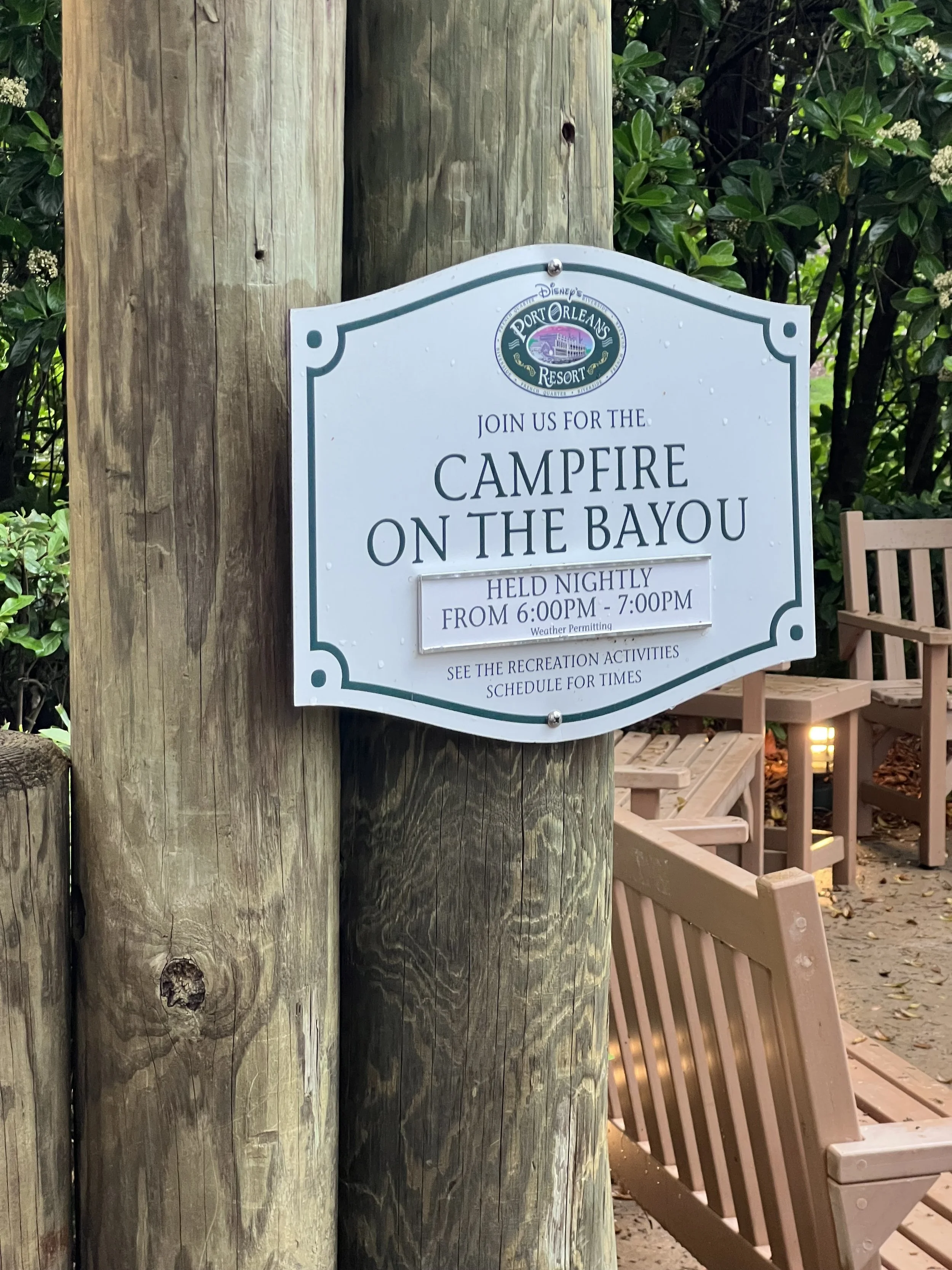 A sign at Disney Port Orleans Resort advertising a nightly campfire event on the bayou from 6:00 PM to 7:00 PM, with a schedule of recreation activities.
