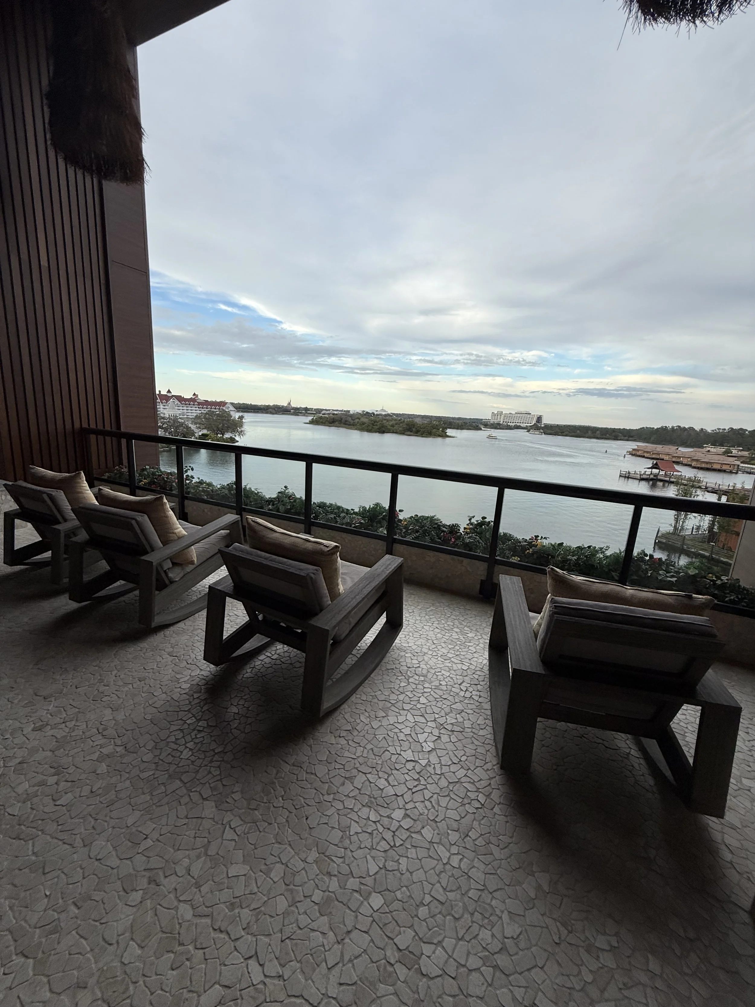 Balcony overlooking a river with a view of buildings and clouds in the sky