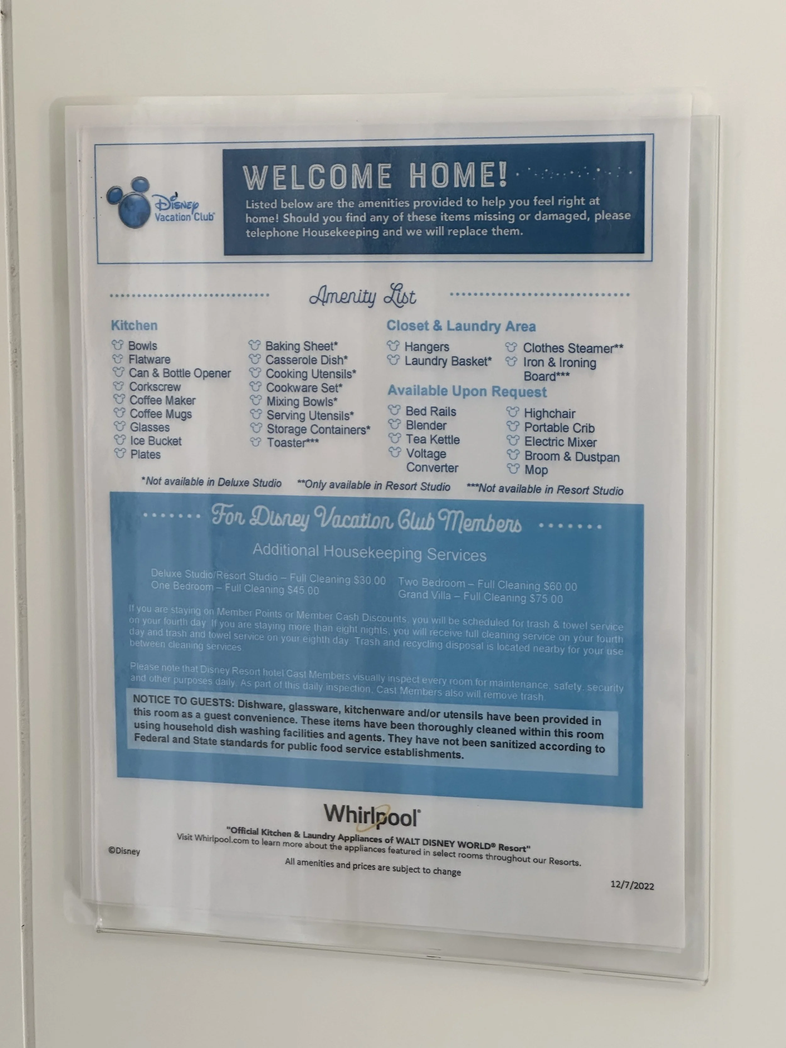 Hotel amenities and policies notice with Disney Vacation Club and Whirlpool branding, listing kitchen and laundry area amenities, additional housekeeping services, and guest protocols.