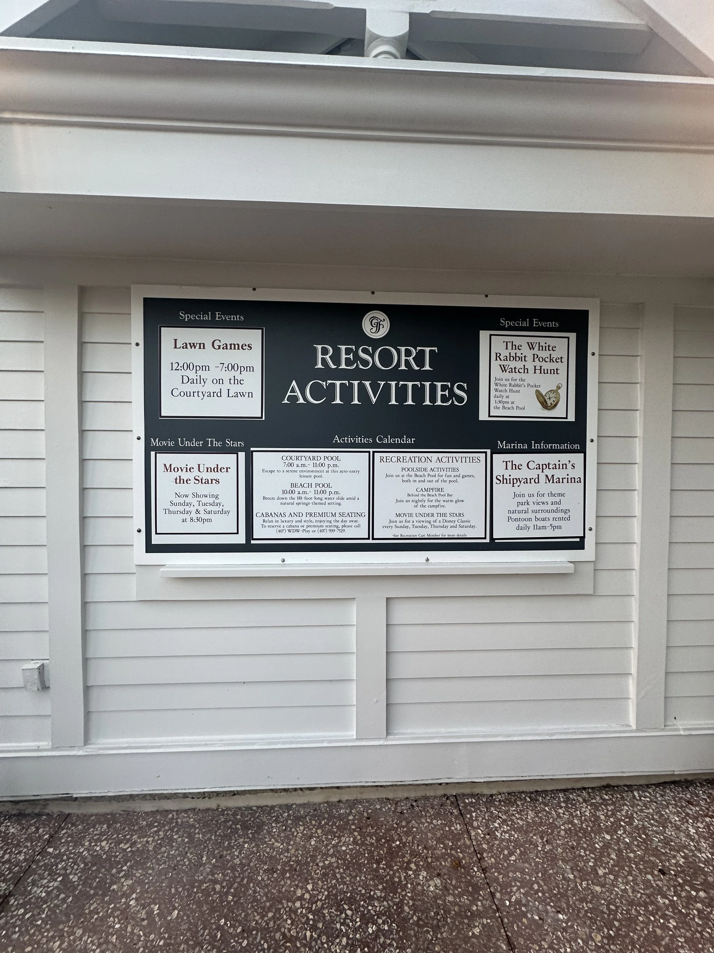 Resort activities bulletin board with schedule of lawn games, movie nights, and special events at the marina, including times and locations.