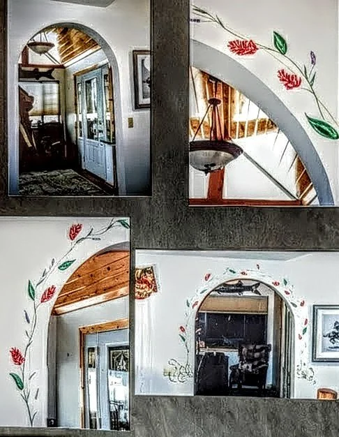 Mural of Indian paintbrush and vines surround an arch