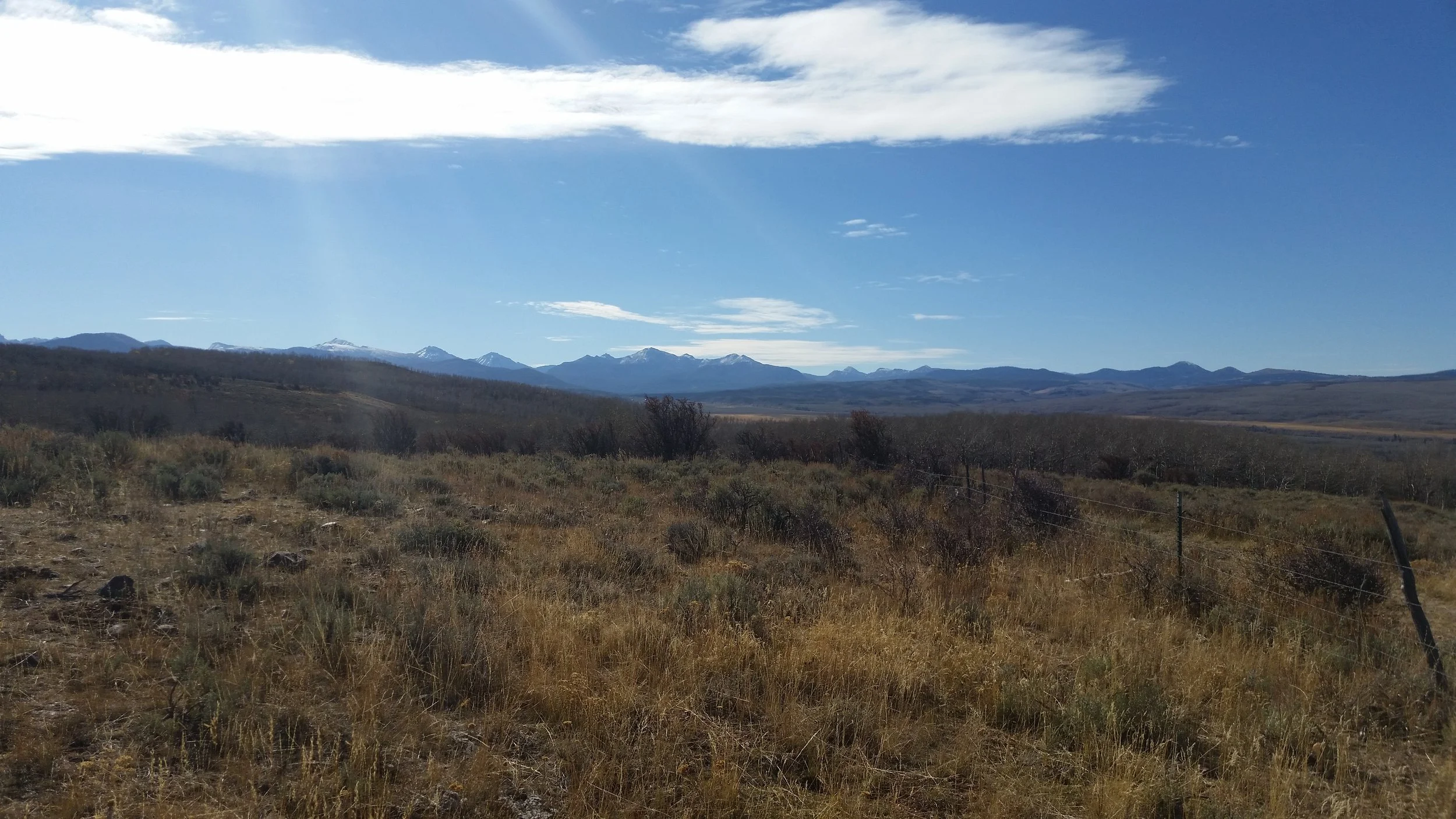 Blue mountains in the background of a wide valley