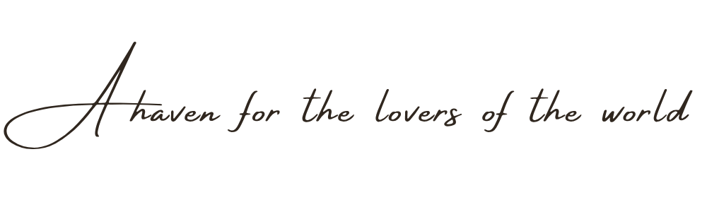 Stylish black background with elegant cursive text saying "A haven for the lovers of the world."