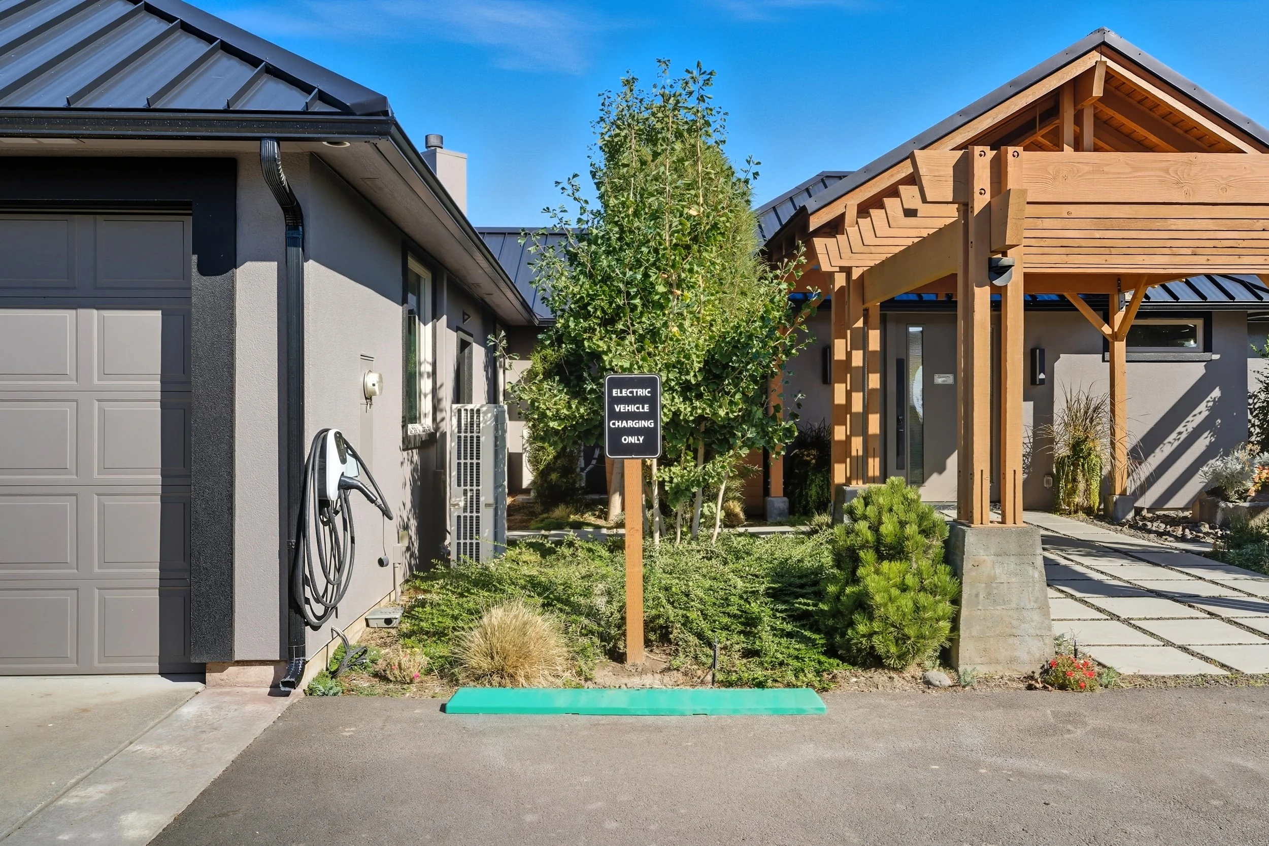 Residential house with electric vehicle charging station in front