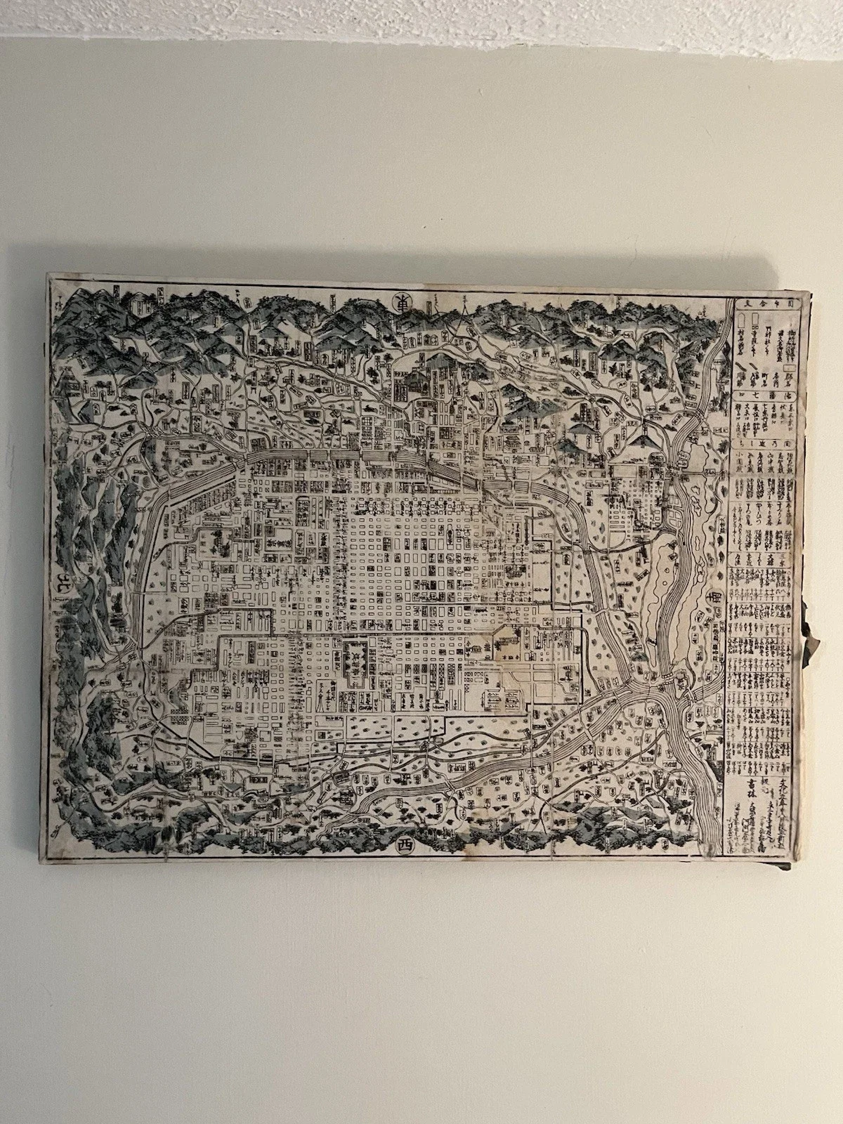 Roman sculpture style candle inside a glass container