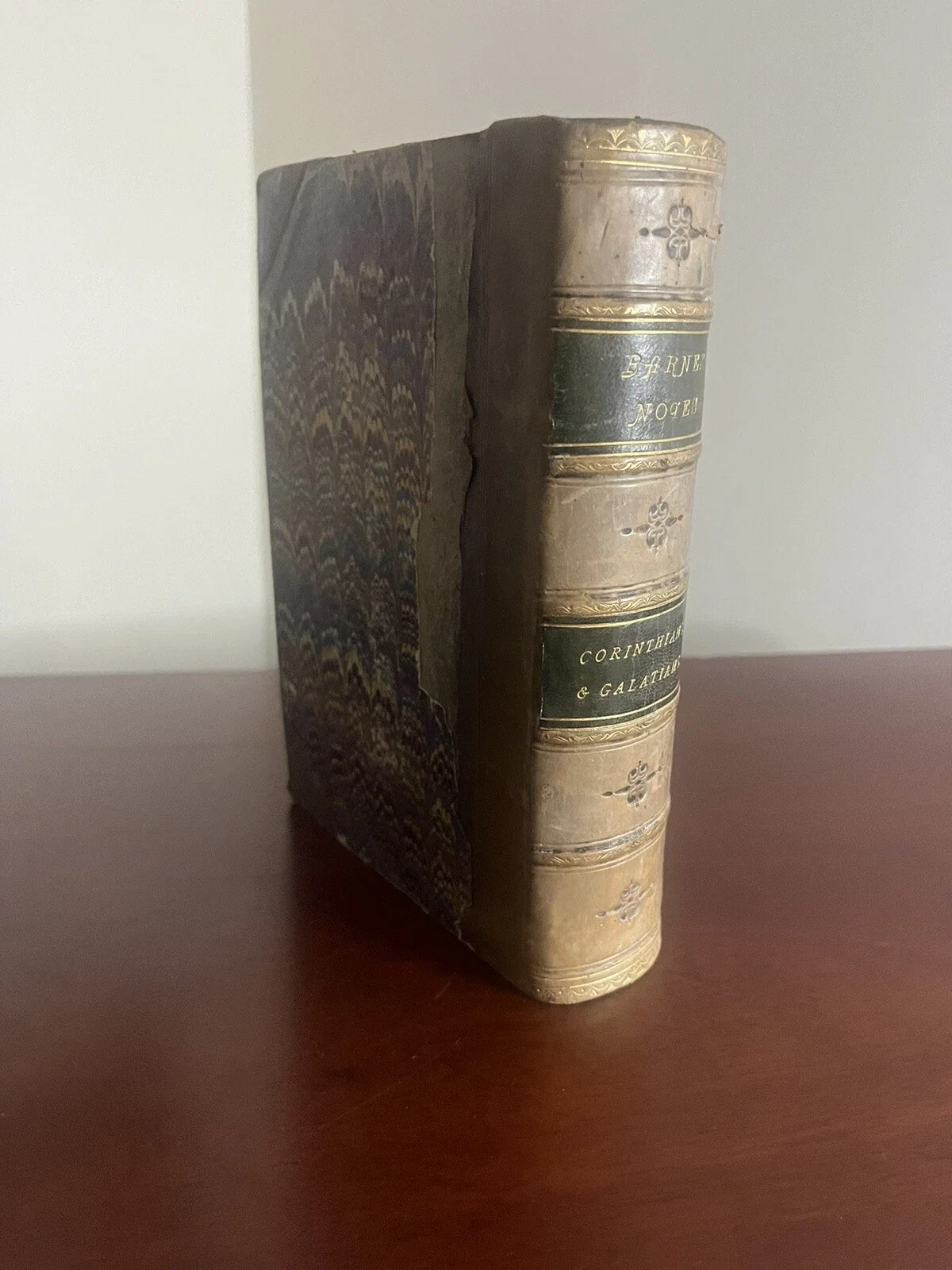 An antique book with a worn leather cover and gold-embossed spine, titled 'CORNELIUS & GALATIA' and 'DERNE NOEL'.