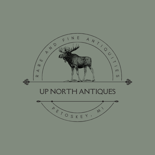 Logo for Up North Antiques featuring a moose and text, with a light green background.