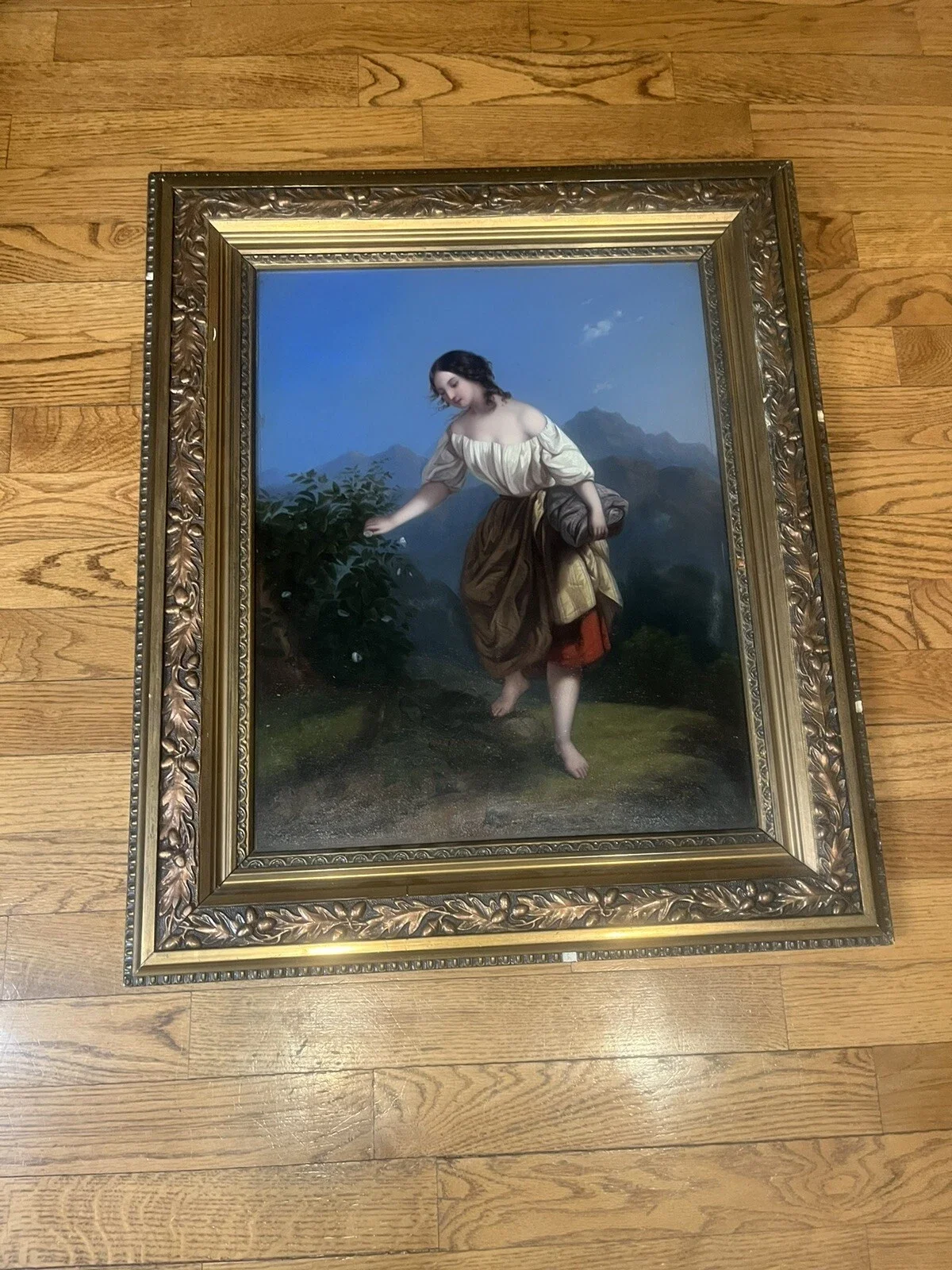 Painting of a young woman with dark hair, wearing a cream off-the-shoulder blouse and a brown skirt, walking barefoot outdoor in a natural setting with mountains in the background.