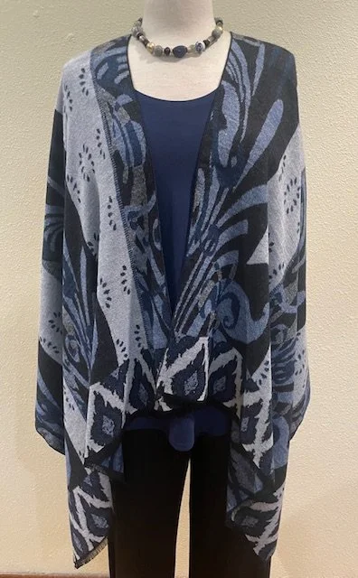 The Rapti Ruana shawl is longer with no buckle closure. Both shawls are reversable.