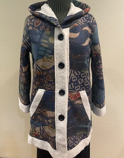The Shana Mixed Print Hoodie is shown here in blue and is also available in a multicolor with a cream background.