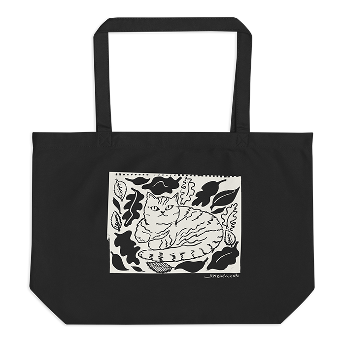 Black tote bag with a black and white sketch of a cat sitting amid leaves.