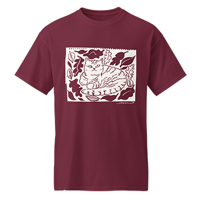 Maroon T-shirt cat surrounded by leaves.