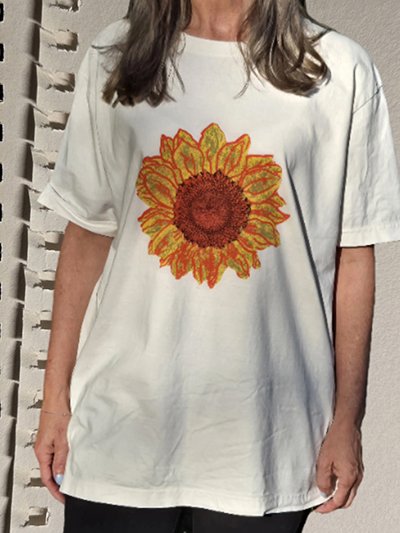 White oversized t-shirt with sunflower graphic on front.