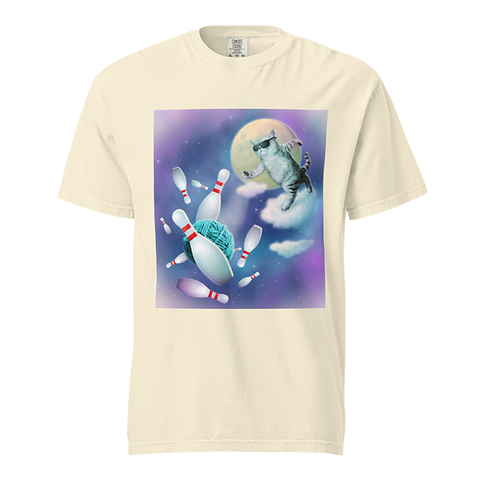 A cartoon-style design on a white T-shirt featuring a cat wearing sunglasses bowling on a starry sky with a full moon, yarn and bowling pins.