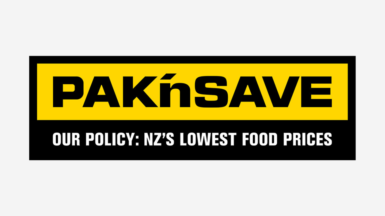 A logo for PAK'nSAVE, a grocery store chain, with the slogan "Our policy: NZ's lowest food prices" in white text on a black background. The logo features bold black and yellow colors.