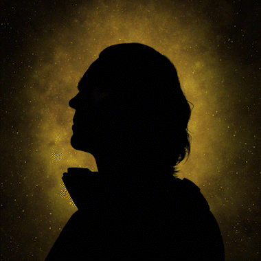 Silhouette of a person with long hair against a yellow nebula background in space. Foundation series on Apple TV+