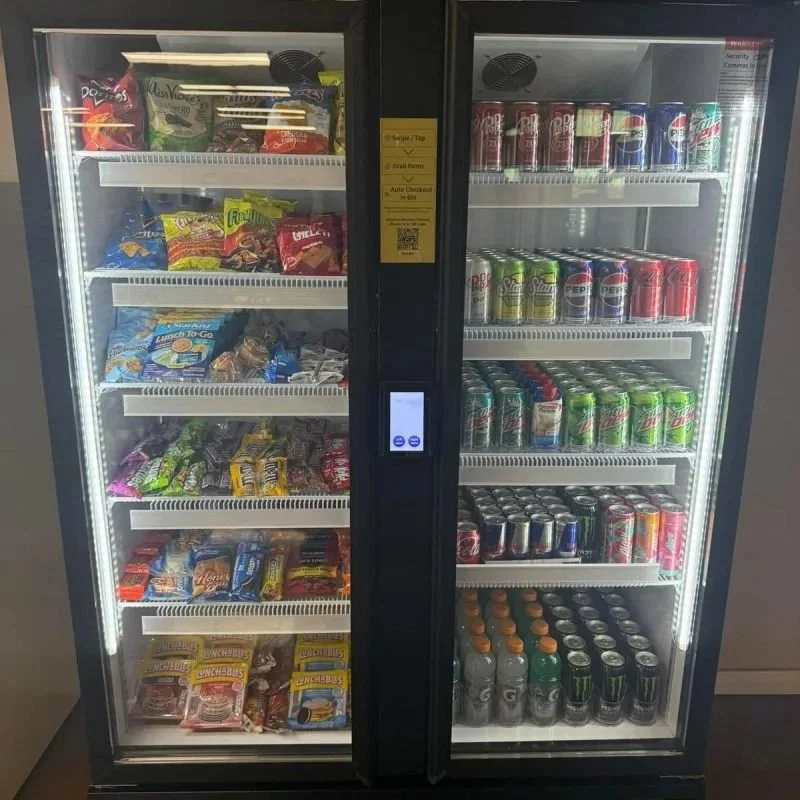 A vending machine with snacks on the left side and canned drinks on the right side.