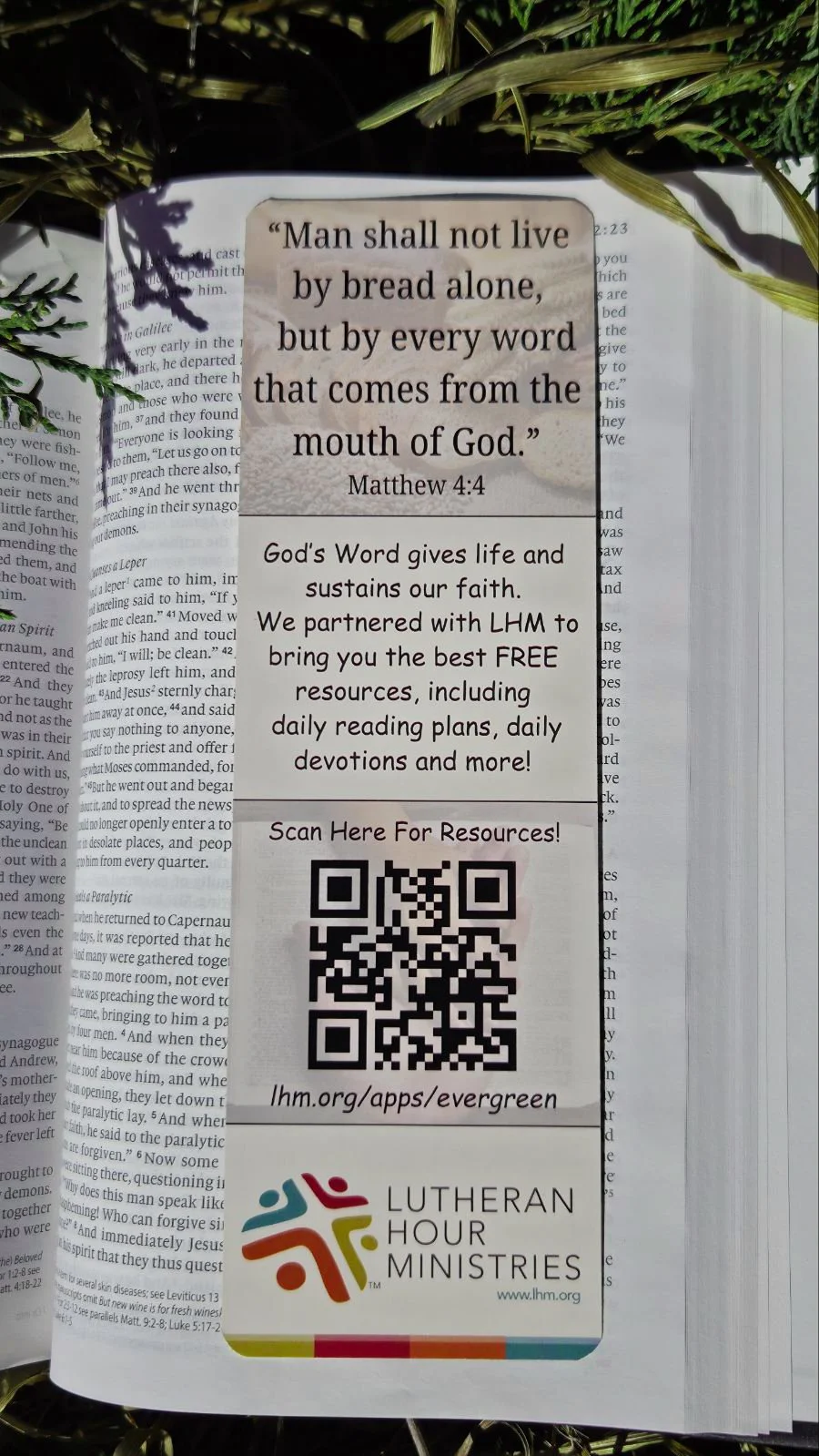 A religious flyer with a Bible verse from Matthew 4:4 and information about free resources from Lutheran Hour Ministries, including a QR code for access.