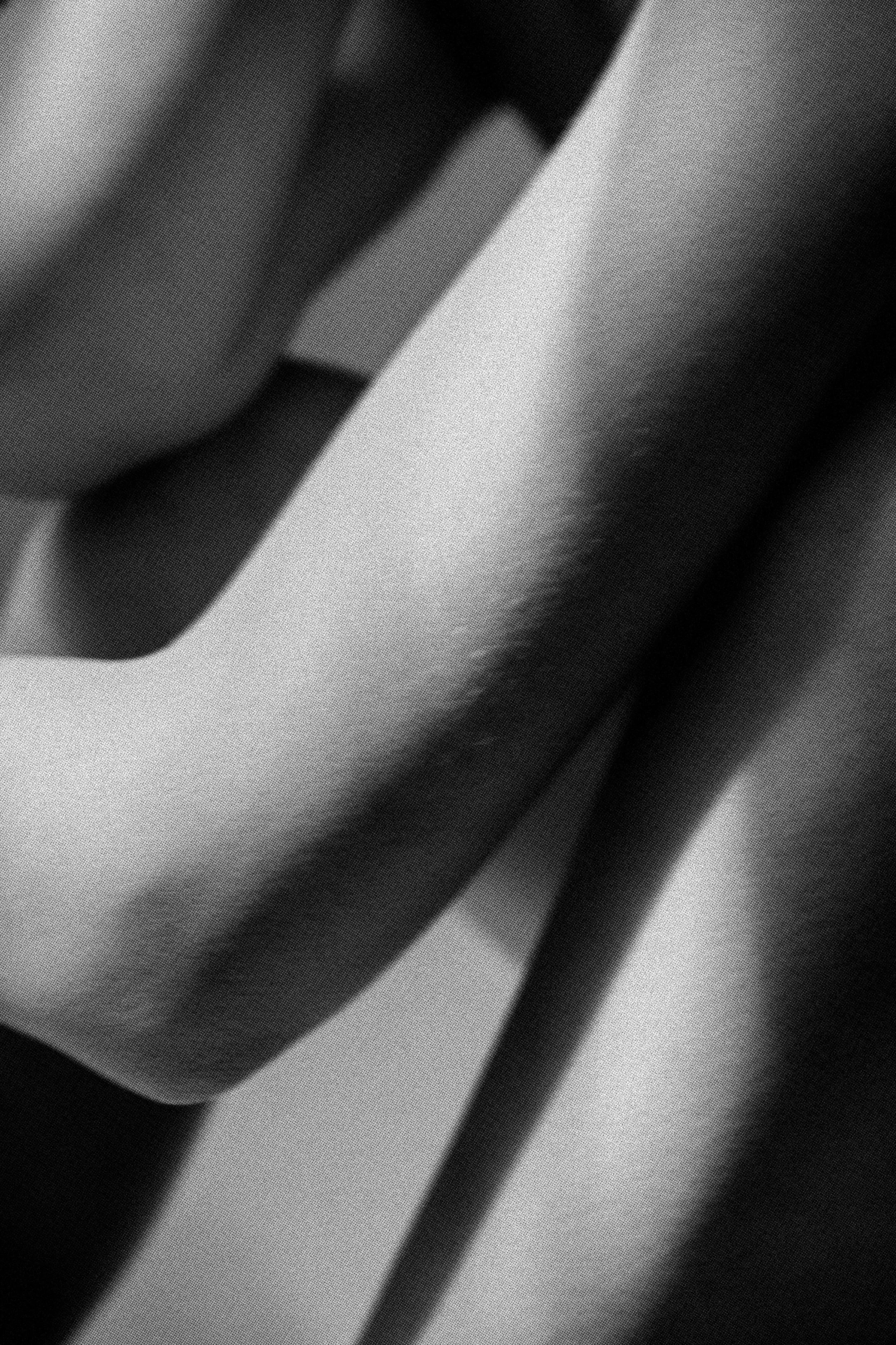 Close-up of metallic metallic objects, possibly parts of appliances, in black and white.