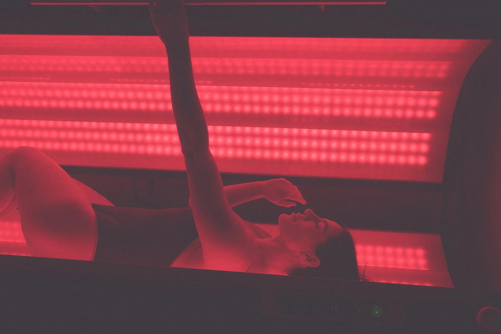 Close-up of a person in black underwear, highlighting a slightly protruding navel, with illuminated dots in the background.