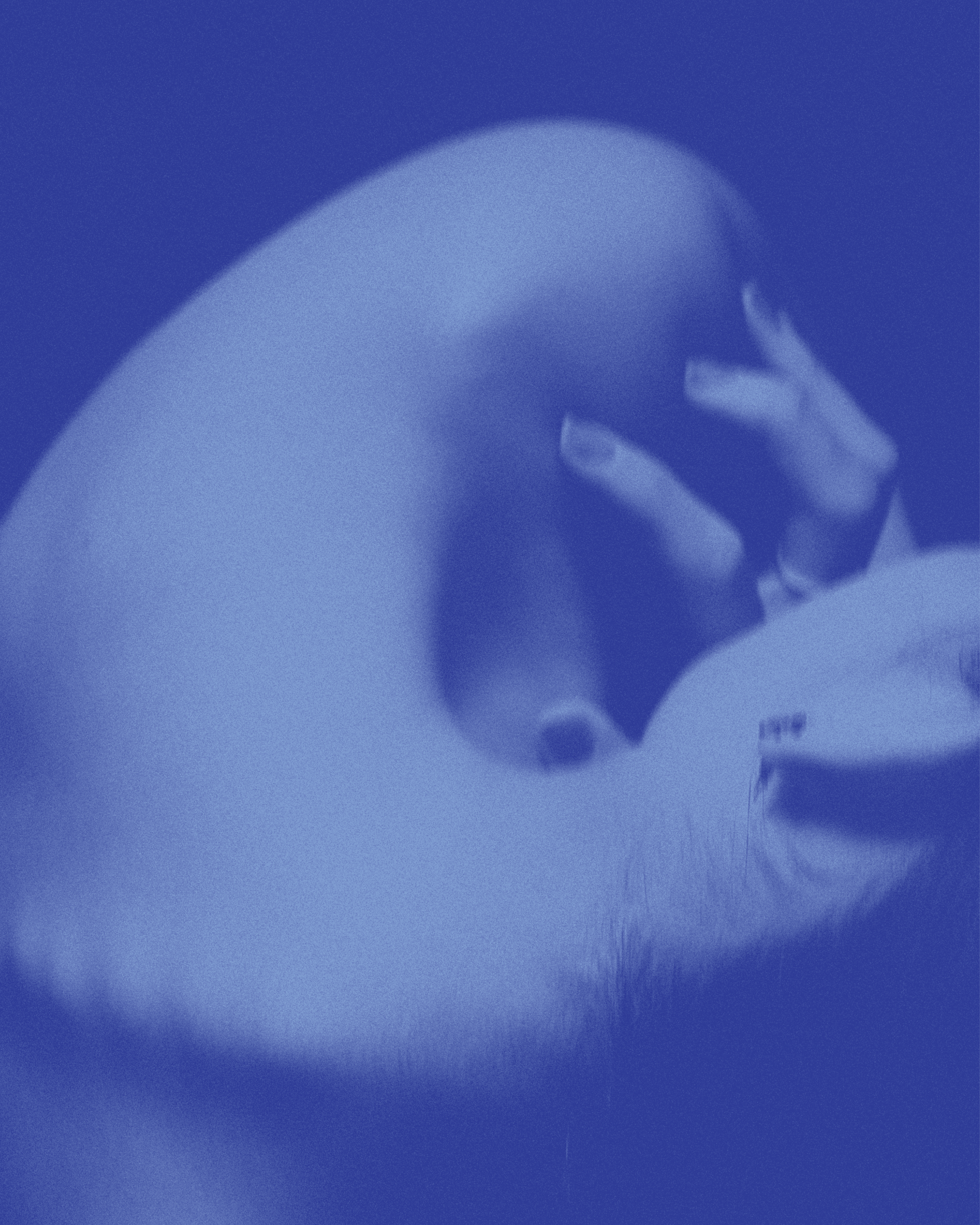 A close-up image of a person's arm and hand with their fingers gently touching their lips, with a blue filter over the photo.