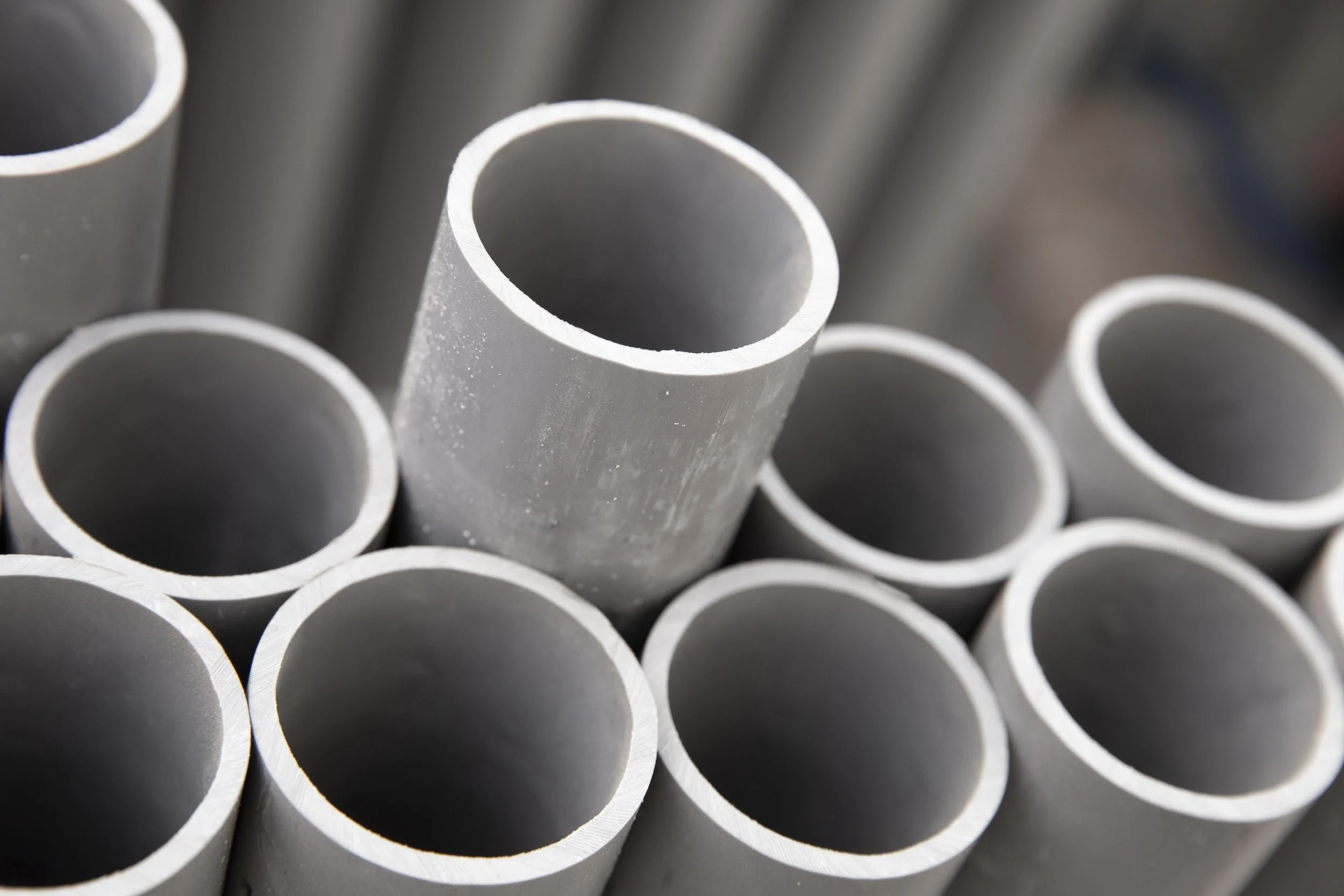 Close-up of metallic pipes stacked together.
