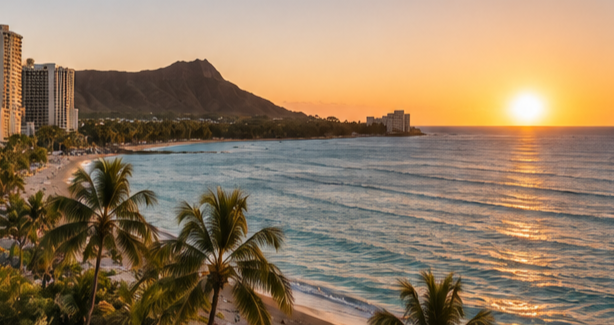 Sunset over Waikīkī Beach, with palm trees and Diamond Head.