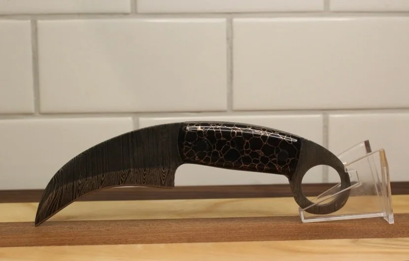 This Blade Is A Damascus Karambit. The Karambit Originated In 11th Century, In Indonesia. It Design Was Made To Resemble The Curved Claws From Big Jungle Cats. Truly An Amazing Piece With Damascus Steel, And Black &amp; Copper Stone Handles. This Bla