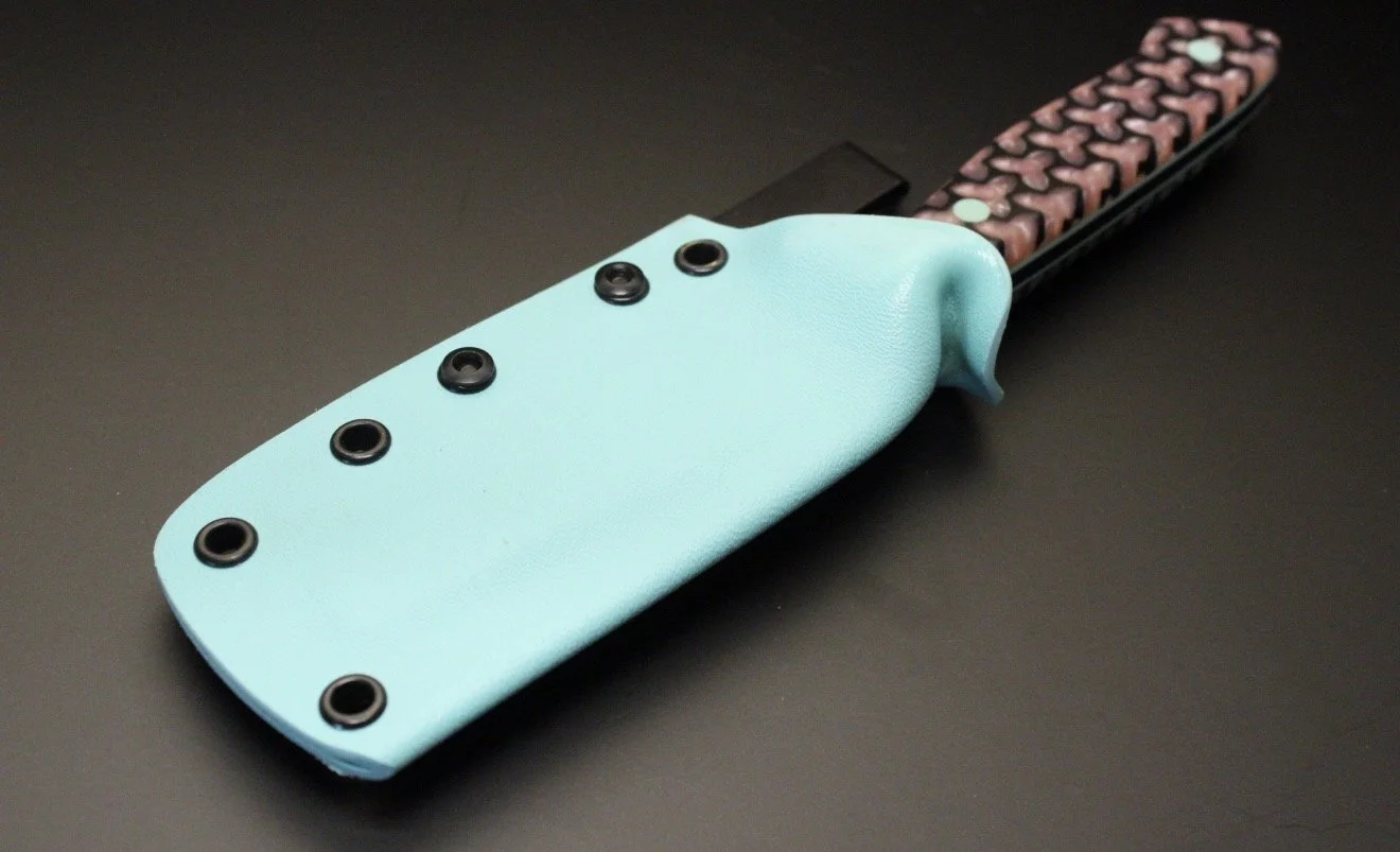 A knife with a light blue kydex sheath