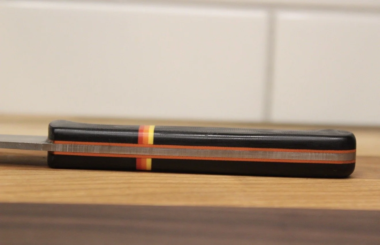 "Canyon" on it's side with black, orange, red, and yellow handles.