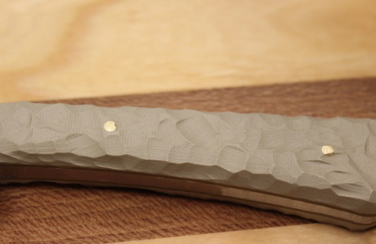 Close-up photo of G10 rock texture handle
