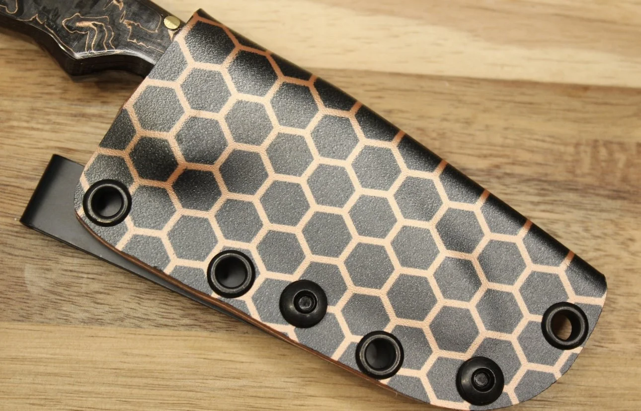 Close-up of a knife with a honeycomb pattern sheath.
