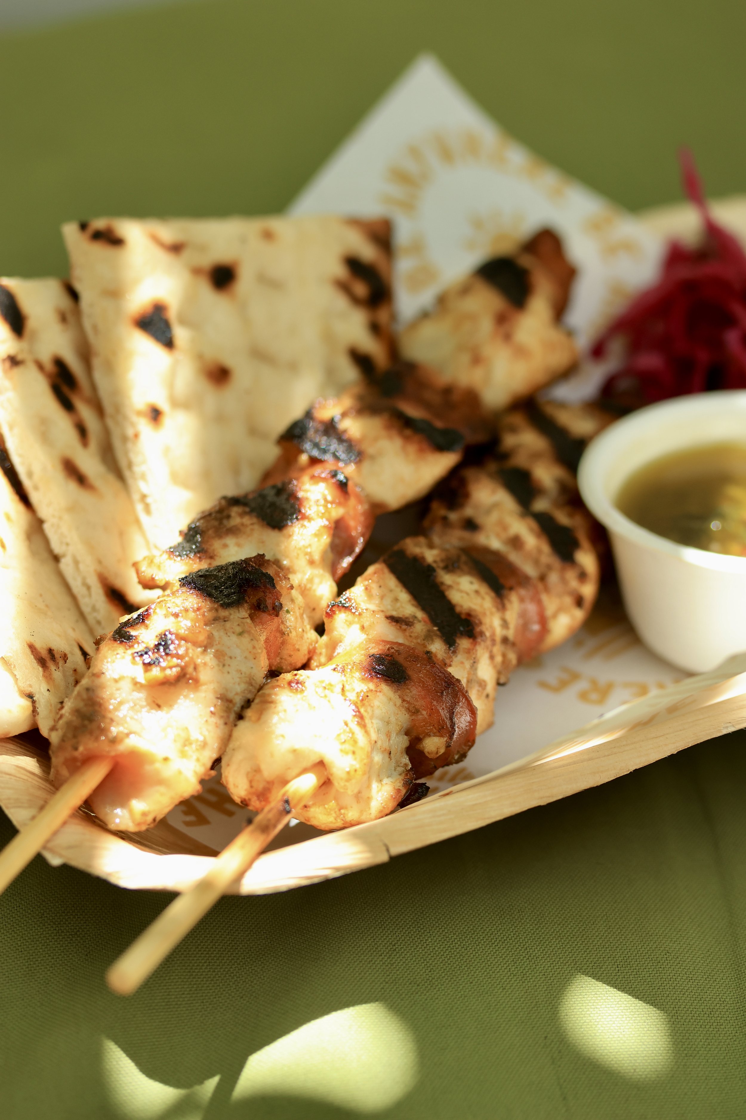 elgan valley chicken with chorizo on a skewer, served with house pickled cabbage and a side of chimichurri and charred flat bread.