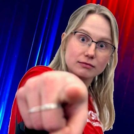 A smiling woman with glasses on her head and earrings, wearing a beige sweater with a colorful pixel pattern.