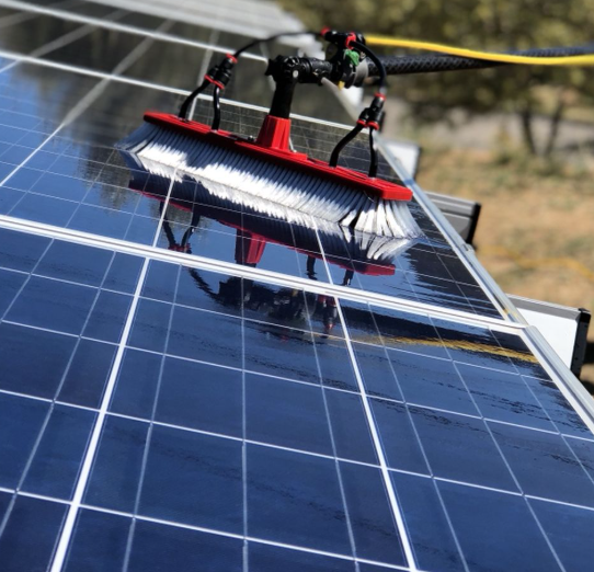 Solar panels being cleaned with pure-water technology