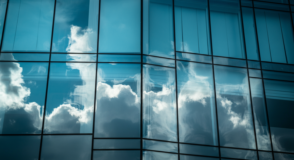 Clouds and blue sky reflected in freshly cleaned glass