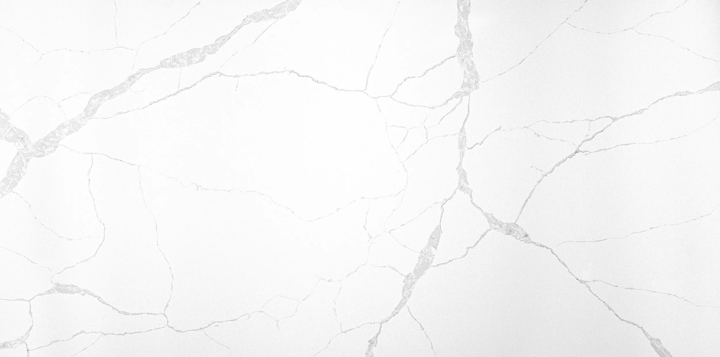 White marble surface with gray veins and cracks.