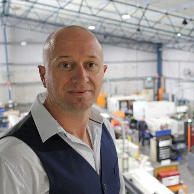 Man standing in warehouse representing client testimonial for Arrow’s outsourced marketing, SEO, and advertising services delivering structured, measurable business outcomes.