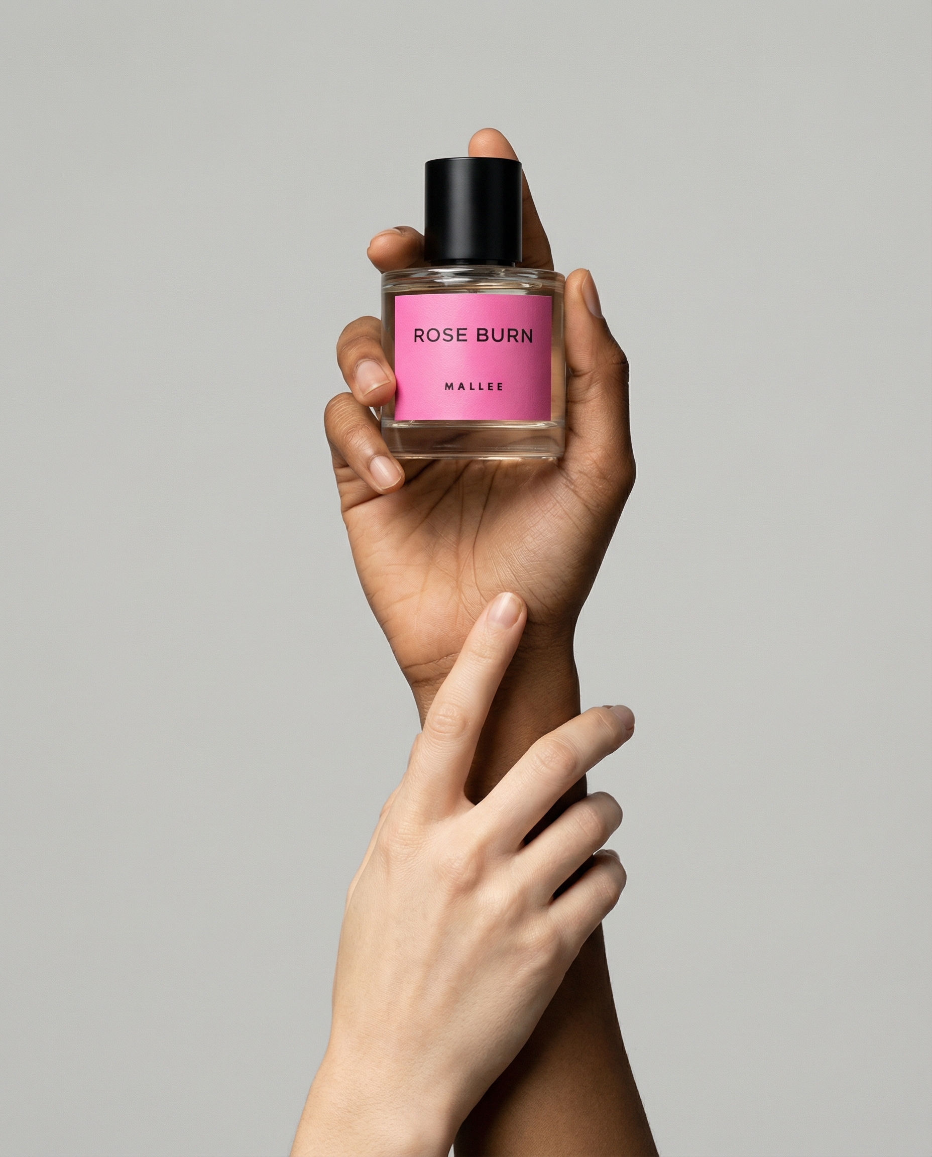 Generated with Kive.ai - create a realistic image similar to the reference holding my perfume bottle_ change background to light grey (2).png