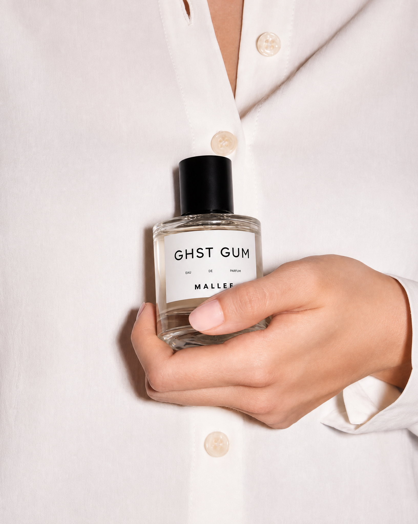 Generated with Kive.ai - Glass perfume bottle recreate a similar reference image holding my perfume bottle.png