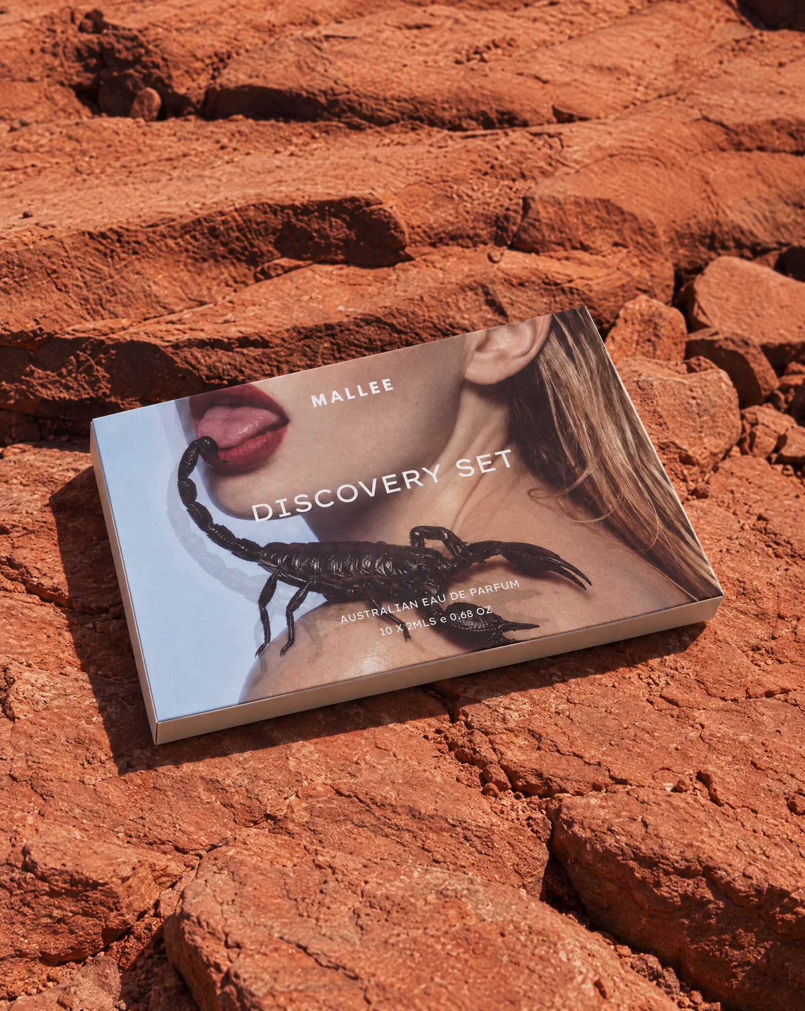 Generated with Kive.ai - Perfume discovery set can you create an image of my product box on the red rocky ground reference.png