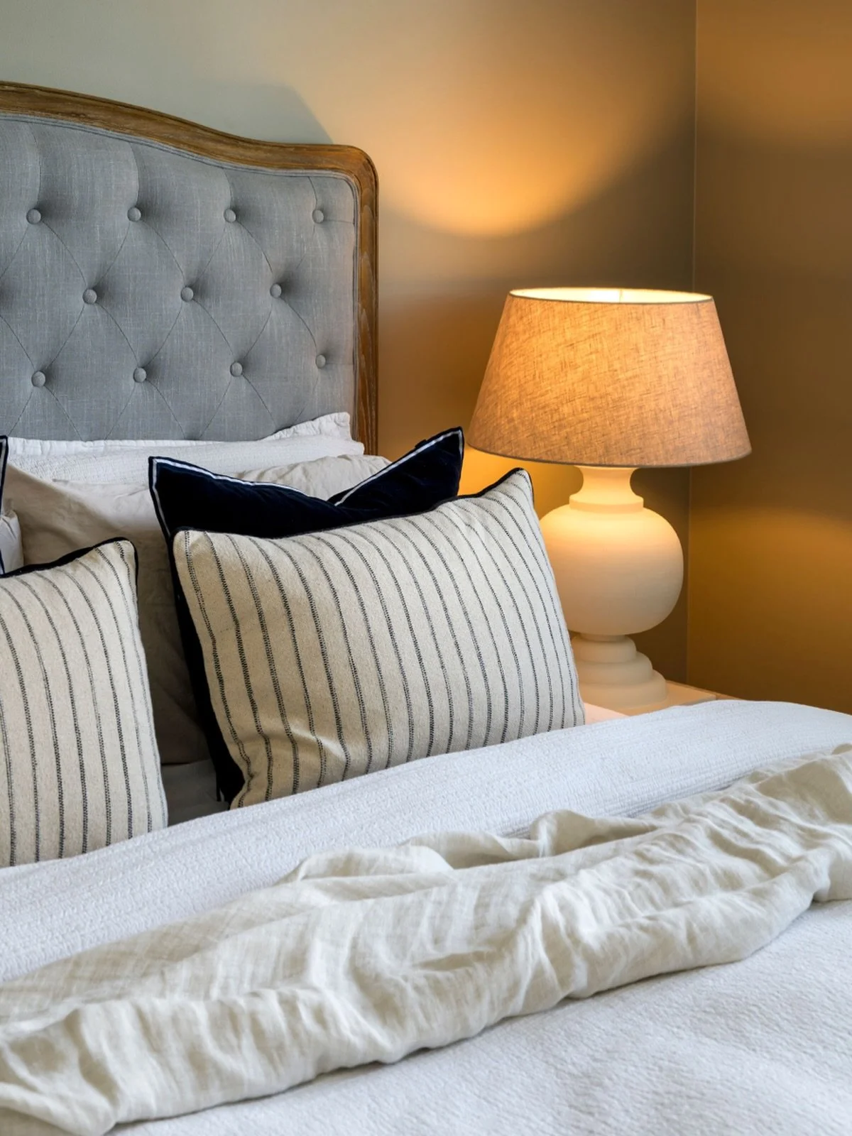 Layers that whisper calm 🤍

This bedroom is all about understated elegance - a beautifully upholstered, button-tufted bedhead framed in aged oak, paired with soft linen, tailored stripes and a hint of deep navy for contrast.

We&rsquo;ve kept the pa